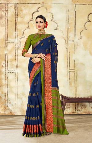 Grab This Very Beautiful Designer Saree With A Royal Silk Touch In Navy Blue Color Paired With Green Colored Blouse. This Saree Is Fabricated On Cotton Silk Paired With Art Silk Fabricated Blouse. It Has Very Elegant Heavy Weaved Border. 