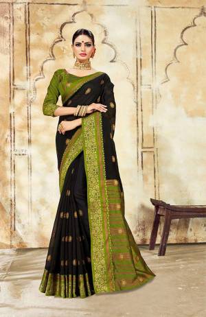 Celebrate This Festive Season With Ease And Comfort Wearing This Royal Looking Silk Based Saree In Black Color Paired With Green Colored Blouse. This Saree Is Cotton Silk Based Paired With Art Silk Fabricated Blouse. Buy Now.