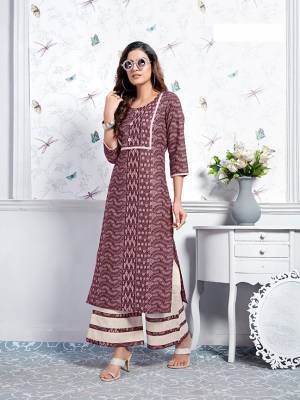 Here Is A Lovely Pair Of Designer Readymade Kurti In Wine Color Paired With White Colored Plazzo. This Kurti And Plazzo Are Fabricated On Cotton Beautified With Prints. It Is Light In Weight And Easy To Carry All Day Long. 