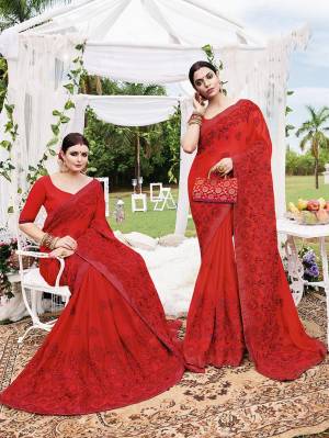 Adorn The Pretty Angelic Look Wearing This Heavy Designer Saree In Red Color Paired With Red Colored Blouse. This Saree Is Fabricated On Silk Georgette Paired With art Silk Fabricated Blouse. It Is Beautified With Pretty Tone To Tone Embroidery. 