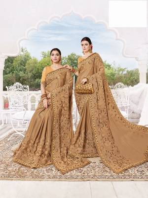 Flaunt Your Rich And Elagant Taste Wearing Very Beautiful And Elegant Looking Heavy Designer Saree In Beige Color. This Heavy Embroidered Saree Is Fabricated On Silk Georgette Paired With Art Silk Fabricated Blouse. 