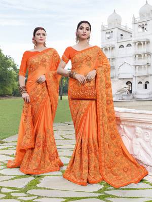 Flaunt Your Rich And Elagant Taste Wearing Very Beautiful And Attractive Looking Heavy Designer Saree In Orange Color. This Heavy Embroidered Saree Is Fabricated On Silk Georgette Paired With Art Silk Fabricated Blouse. 
