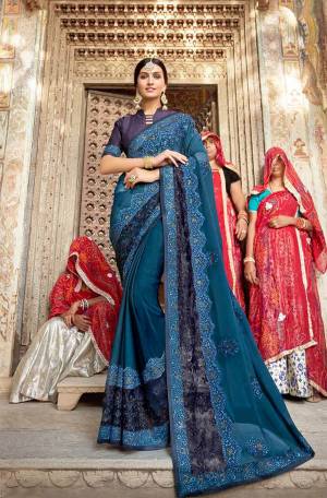 Enhance Your Personality In This Beautiful and Heavy Embroidered Designer Saree In Blue color Paired With Navy Blue Colored Blouse. This Saree Is Fabricated On Georgette Paired With art silk Fabricated Blouse. 