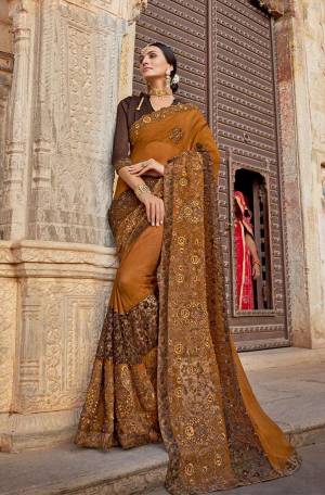 Enhance Your Personality In This Beautiful and Heavy Embroidered Designer Saree In Musturd color Paired With Brown Colored Blouse. This Saree Is Fabricated On Chiffon Georgette Paired With art silk Fabricated Blouse. 