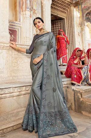 Flaunt Your Rich And Elegant Taste Wearing This Heavy Designer Saree In Grey Color. This Saree Is Fabricated on Silk Georgette Paired With Art Silk Fabricated Blouse. Buy This Lovely Saree Now.