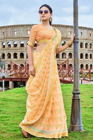 Grab This Simple And Elegant Printed Saree For Your Casuals Or Semi-Casuals In Light Orange Color. This Saree And Blouse Are Fabricated Cotton Chiffon Which Is Light In Weight And Easy To Carry All Day Long. 