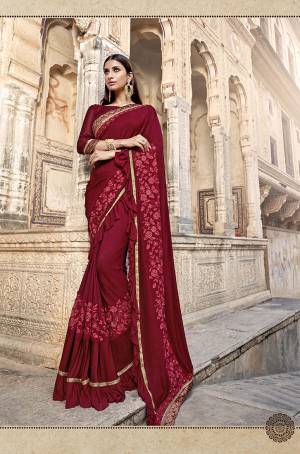Here Is A Royal Looking Designer Saree In Maroon Color Paired With Maroon Colored Blouse. This Saree Is Fabricated On Lycra Paired With Art Silk Fabricated Blouse. It Is Bautified With Hand Work Patch And Fancy Lace Border.