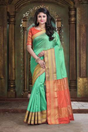 Simple And Elegant Silk Based Saree For Your Casual Or Semi-Casual Wear In Light Green Color Paired With Contrasting Orange Colored Blouse. This Saree Is Light In Weight And easy To Carry all Day Long.