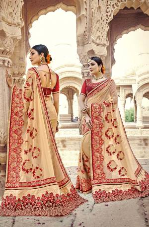 Flaunt Your Rich And Elegant Taste Wearing this Heavy Designer Saree In Cream Color Paired With Red Colored Blouse. This Heavy Embroidered Saree Is Fabricated On Georgette Paired With Art Silk Fabricated Blouse.