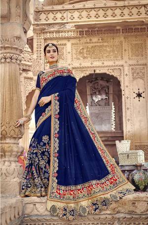 Attract All Wearing This Very Beautiful Heavy Designer Saree In Royal Blue Color. This Saree And Blouse Are Silk Based Beautified With Heavy Embroidery All Over It. 