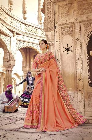 Attract All Wearing This Very Beautiful Heavy Designer Saree In Light Orange Color. This Saree And Blouse Are Silk Based Beautified With Heavy Embroidery All Over It. 