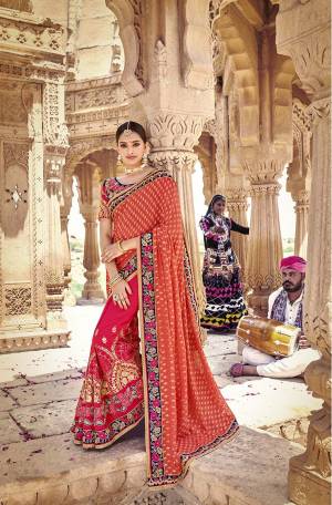 For A Royal Look, Grab This Heavy Designer Saree In Orange & Dark Pink Color Paired With Navy Blue Colored Blouse. This Saree Is Fabricated On Brasso And Soft Silk Paired With Art Silk Fabricated Blouse. It Has Heavy Attractive Embroidery Which Will Definitely Earn You Lots Of Compliments From Onlookers.