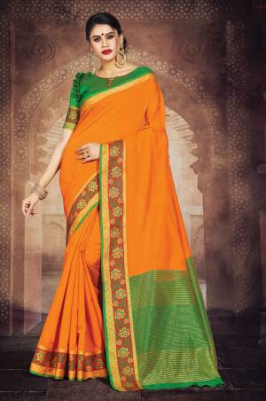 Simple And Elegant Silk Based Saree For Your Casual Or Semi-Casual Wear In Orange Color Paired With Contrasting Green Colored Blouse. This Saree Is Light In Weight And easy To Carry all Day Long.