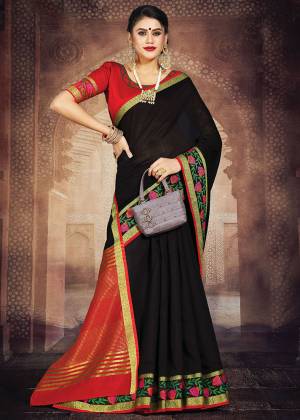 Flaunt Your Rich And Elegant Taste In This Simple Saree In Black Color Paired With Red Colored Blouse. This Saree And Blouse Are Fabricated On Art Silk Whih Gives A Rich Look To Your Personality. 