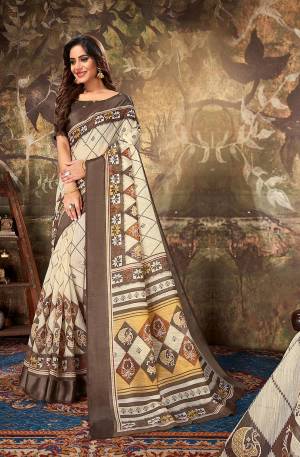 Look Pretty Wearing This Designer Printed Saree In Cream Color Paired With Brown Colored Blouse. This Saree Is Fabricated On Cotton Paired With Cotton Silk Fabricated Blouse. 