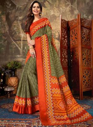 Here Is A Very Pretty Printed Saree In Olive Green Color Paired With Orange Colored Blouse. This Saree Is Cotton Based Paired With Cotton Silk Fabricated Blouse. It Is Light In Weigh And Easy To Drape, Which Is Easy To Carry All Day Long. 