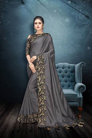 Flaunt Your Rich And Elegant Taste In This Plain Saree In Grey Color Paired With Black Colored Blouse. This Silk Based Saree And Rich Color Pallete Will Earn You Lots Of Compliments From Onlookers.