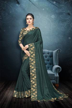 Here Is A Rich And Elegant Looking Designer Saree In Teal Green Color Paired With Teal Green Colored Blouse. This Saree And Blouse Are Silk Based Beautified With Lace Border And Tassels Over The Pallu Border. 