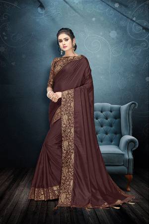 Flaunt Your Rich And Elegant Taste In This Plain Saree In Brown Color Paired With Brown Colored Blouse. This Silk Based Saree And Rich Color Pallete Will Earn You Lots Of Compliments From Onlookers.