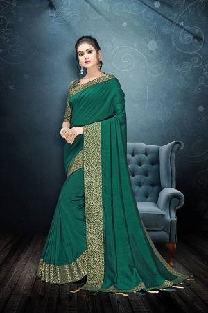 Flaunt Your Rich And Elegant Taste In This Plain Saree In Green Color Paired With Green Colored Blouse. This Silk Based Saree And Rich Color Pallete Will Earn You Lots Of Compliments From Onlookers.