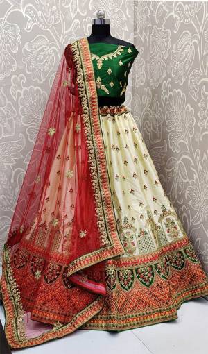 Add This Beautiful Attractive Looking Designer Lehenga Choli In Green Colored Blouse Paired With Cream Colored Lehenga And Red Colored Dupatta. This Lehenga Choli Are Fabricated On Satin Silk Paired With Net Fabricated Blouse. It Is Beautified With Heavy Embroidery All Over. Buy Now.