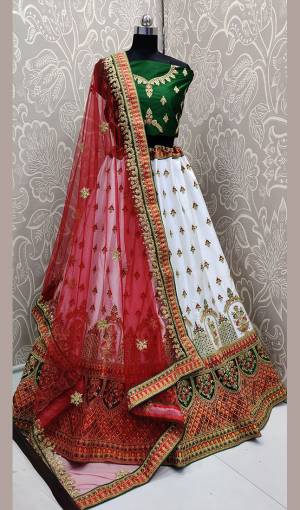 Add This Beautiful Attractive Looking Designer Lehenga Choli In Green Colored Blouse Paired With White Colored Lehenga And Red Colored Dupatta. This Lehenga Choli Are Fabricated On Satin Silk Paired With Net Fabricated Blouse. It Is Beautified With Heavy Embroidery All Over. Buy Now.