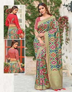 Mesmerize in this classic weaved silk saree in abstract motif in vivid colors paired with two-blouse styles and flaunt that timeless appeal. Fancy up by adding the tissue jacket to the look. 