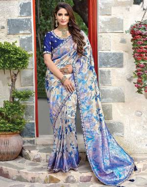 Look like a modern royalty in this fantastic floral printed saree with muted weaved details. The designer blouse is an added style statement . 