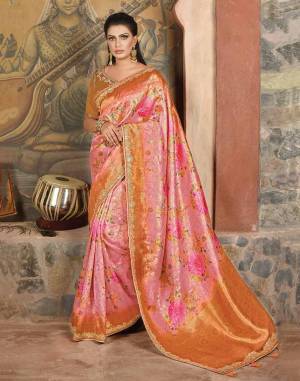 Emitting luxury and class, this pink-orange printed silk saree with sublime weaves makes it a best choice for the festivities this season. Pair with your favourite chandbalis to complete the look. 