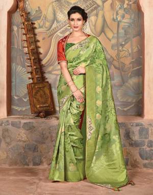 The subtly floral printed silk saree in a harmonious shade of green paired with a contrast orange blouse is an epitome of style and grace. Drape it in a falling pallu style for that beautiful appeal. 