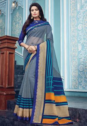 Shine Bright Wearing This Saree In Grey Color Paired With Royal Blue Colored Blouse. This Saree Is Fabricated On Super Net Paired With Art Silk Fabricated Blouse. It Is Beautified With Prints All Over.