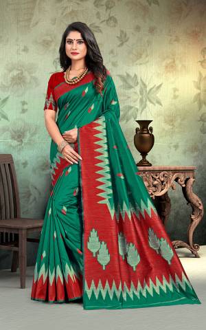 Simple And Elegant Silk Based Saree For Your Casual Or Semi-Casual Wear In Green Color Paired With Contrasting Red Colored Blouse. This Saree Is Light In Weight And easy To Carry all Day Long.