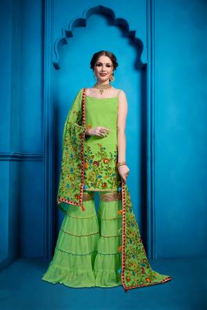 Grab This Beautiful Sharara Suit For the Upcoming Wedding And Festive Season In Parrot Green Color. This Pretty Heavy Embroidered Suit Is Fabricated On Georgette Beautified With Multi Colored Resham Embroidery. Buy This Semi-Stitched Suit Now.