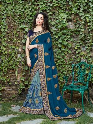 Go With The Pretty Shades Of Blue Wearing This Designer Saree In Blue And Steel Blue Color Paired With Navy Blue Colored Blouse. This Saree Is Fabricated On Chiffon And Georgette Paired With Art Silk Fabricated Blouse. 