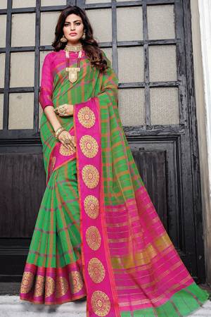 Add This Pretty Designer Saree To Your Wardrobe In Green Color Paired With Contrasting Rani Pink Colored Blouse. This Saree And Blouse Are Fabricated On Cotton Silk Beautified With Prints And Weave. Buy Now.