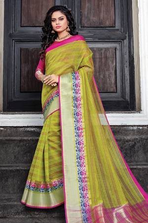 Celebrate This Festive Season Wearing This Saree In Green Color Paired With Contrasting Rani Pink Colored Blouse. This Saree And Blouse Are Cotton Silk Beautified With Weave and Prints. Buy Now.