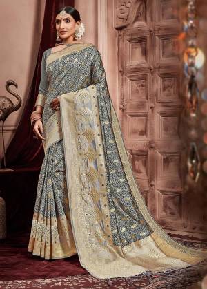 Flaunt Your Rich And Elegant Taste Wearing This Designer Silk Based Heavy Weaved Saree In Grey Color Paired With Grey Colored Blouse. Its Rich Fabric And Elegant Color will Give A Unique Look To Your Personality, Also Its Fabric Is Durable And Easy To Carry All Day Long. 