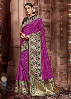 Celebrate This Festive In A Traditional Look Wearing This Designer Saree In Magenta Pink Color Paired With Black Colored Blouse. This Saree And Blouse Are Silk Based Beautified With Weave. Buy This Saree Now.
