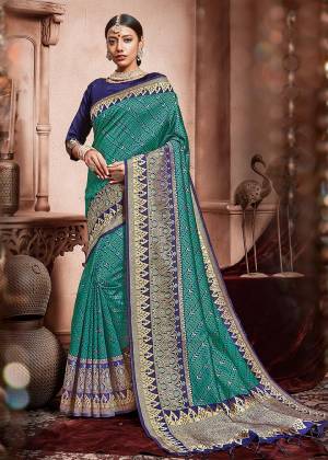 Add This Pretty Saree To Your Wardrobe In Sea Green Color Paired With Royal Blue Colored Blouse. This Saree And Blouse Are Silk Based Beautified With Heavy Deatiled Weave All Over It. 