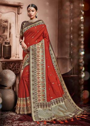 Look Beautiful In This Very Pretty Orange Colored Designer Saree Paired With Contrasting Brown Colored Blouse. This Saree And Blouse Are Silk Based Beautified With Weave All Over. Its Rich Fabric And Color Will Earn You Lots Of Compliments From Onlookers. 