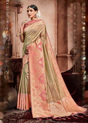 Add This Pretty Saree To Your Wardrobe In Dusty Pink And Light Green Color Paired With Dusty Pink Colored Blouse. This Saree And Blouse Are Silk Based Beautified With Heavy Deatiled Weave All Over It. 