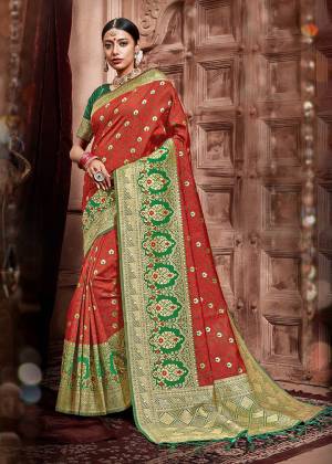 Celebrate This Festive In A Traditional Look Wearing This Designer Saree In Red And Green Color Paired With Dark Green Colored Blouse. This Saree And Blouse Are Silk Based Beautified With Weave. Buy This Saree Now.