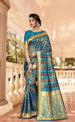 Go With The Pretty Blues With This Designer Checks Patterned Saree In Blue And Navy Blue Color Paired With Blue Colored Blouse. This Saree Is Jacquard Silk Based Paired With Art Silk Fabricated Blouse. 