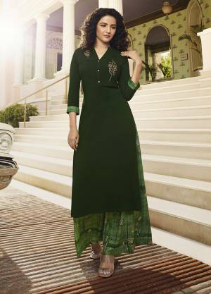 Celebrate This Festive Season With Beauty And Comfort Wearing This Designer Readymade Pair Of Kurti In Dark Green Color Paired With Green Colored Plazzo. This Readymade Set Is Fabricated On Rayon Beautified With Prints And Resham Work. 