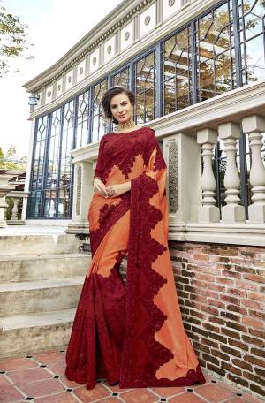 You Will Definitely Earn Lots Of Compliments Wearing This Attractive Looking Heavy Designer Saree In Orange And Maroon Color Paired With Maroon Colored Blouse. This Pretty Detailed Embroidered Saree Is Satin Georgette Based Paired With art Silk Fabricated Embroidered Blouse. 