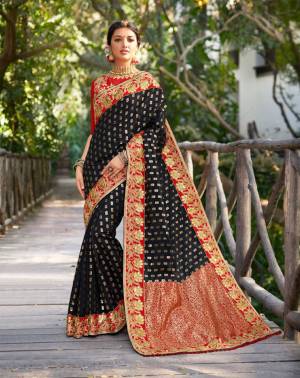 For A Bold And Beautiful Look, Grab This Heavy Designer Saree In Black Color Paired With Red Colored Blouse. This Saree Has Rich Jacquard Silk Fabricated Paired With Art Silk Fabricated Blouse. Buy This Lovely Piece Now.