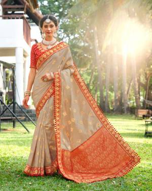 Flaunt Your Rich And Elegant Taste In Subtle And Elegant Shades With This Designer Saree In Pale Grey Color Paired With Contrasting Red colored Blouse. This Silk Based Saree And Its Elegant Color Pallete Will Give A Great Look To Your Personality.  