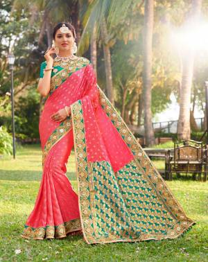 Look Pretty In This Lovely Pink Colored Designer Saree Paired With Contrasting Sea Green colored Blouse. This Saree Is Fabricated On Jacquard Silk Paired With Art Silk Fabricated Blouse. 