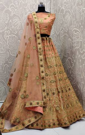 Get Ready For The Upcoming Wedding Season With This Very Pretty Heavy Embroidered Designer Lehenga Choli In Peach Color. This Beautiful Lehenga Choli Is Fabricated On Satin Silk Paired With Net Fabricated Dupatta. Buy Now. 