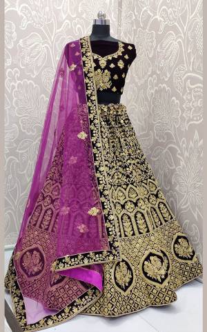 Here Is a Proper Heavy Traditional Lehenga Choli For The Upcoming Wedding Season In Dark Wine Color Paired with A Very Pretty Magenta Pink Colored Dupatta. This Heavy Embroidered Designer Lehenga Choli Is Fabricated On Velvet Paired With Net Fabricated Dupatta. Buy This Beautiful Traditional Piece Now.